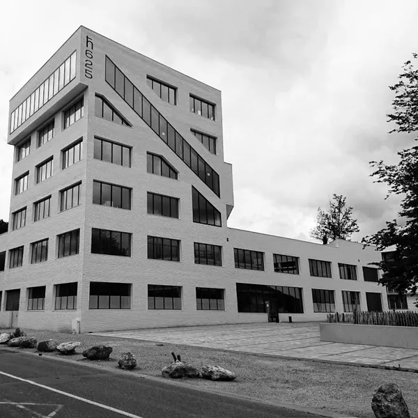 A monochrome building facade with repeated window grids